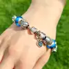 Bratara pentru iubire, tip Pandora, suflata cu argint si sticla Murano cu charmuri inima dragostei si simboluri norocoase