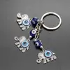 Breloc 3 elefanți cu trompa în sus si ochiul magic norocos albastru, amuletă feng shui de protecție și noroc, metal solid argintiu 11 cm