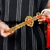 Sabia cu monede chinezesti, impotriva invidiilor si furtului, amuleta feng shui Pi Hsien Chien, metal auriu cu snur rosu